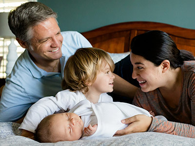 family-safe-laughing-on-bed